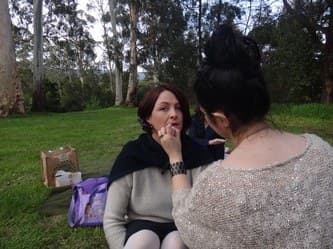 Vasii doing a client's makeup on location